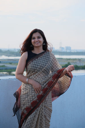 Rust-red pallu with lotus motifs on Ananya Lotus Kota Doria saree