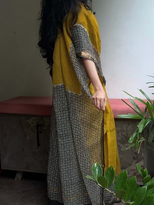 Seated view of Aaranya mustard Kota Doria saree with floral pallu