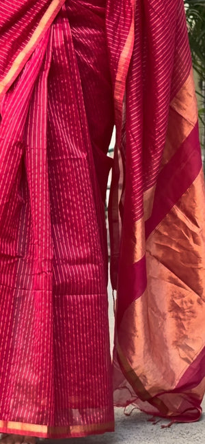 Close-up of Mrinalini saree with fine stripes and gold-toned border and pallu