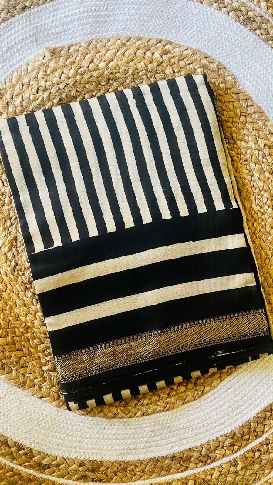 Folded black and ivory striped Maheshwari handblocked silk cotton saree