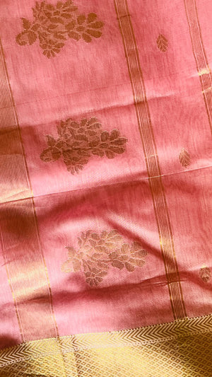 Folded gulabi-pink Maheswari saree showing the gold zari pallu and border