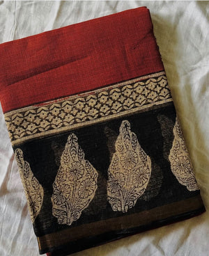 Ruhani brick red Kota Doria saree with black and ivory floral motifs and a gold-toned border