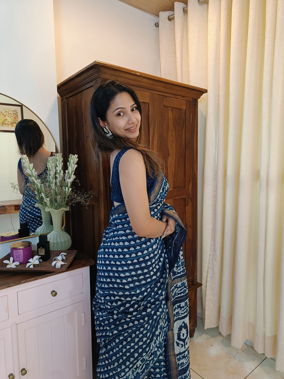 Close view of the indigo saree with ivory handblocked motifs, contrast border, and patterned pallu