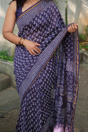 Close-up of Aadhira saree white motifs, chevron border and slim gold-toned edging