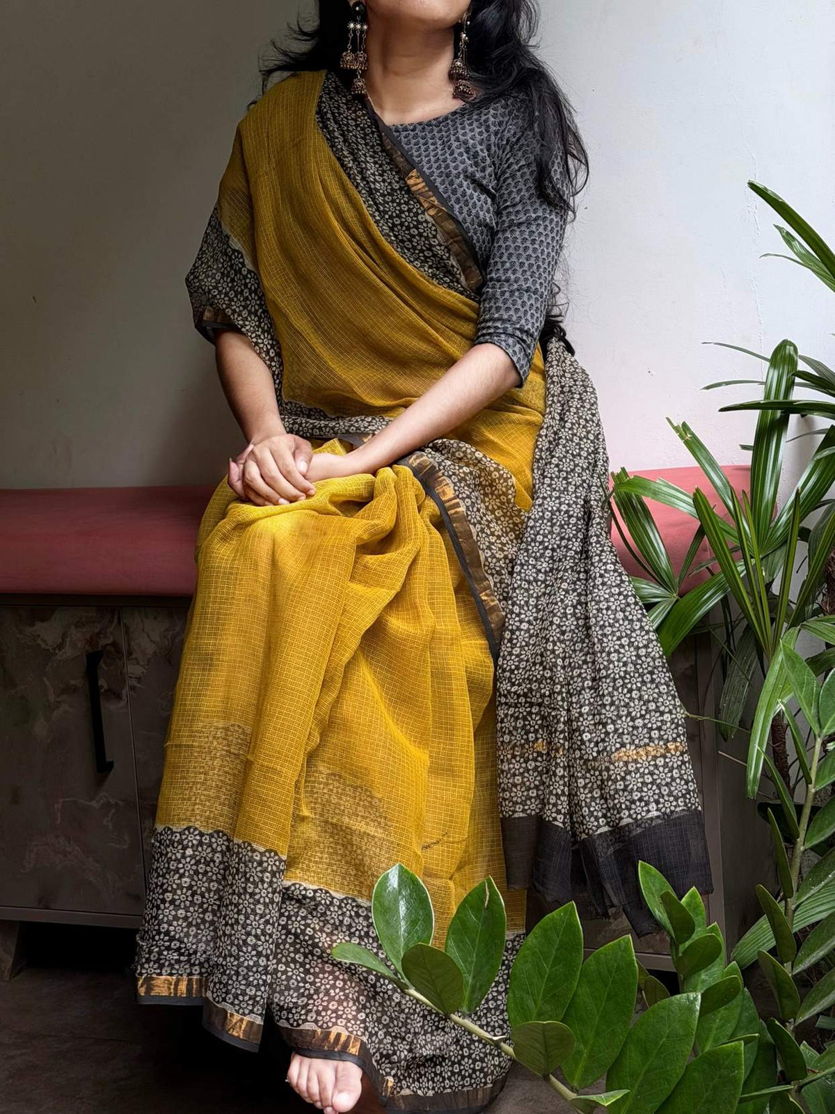 Aaranya Kota Doria saree showing the dark floral pallu against the mustard body