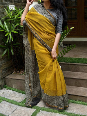 Side view of Aaranya mustard Kota Doria saree and dark floral pallu