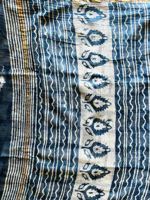 Close-up of ivory blooms and dotted trails on the indigo Mira saree