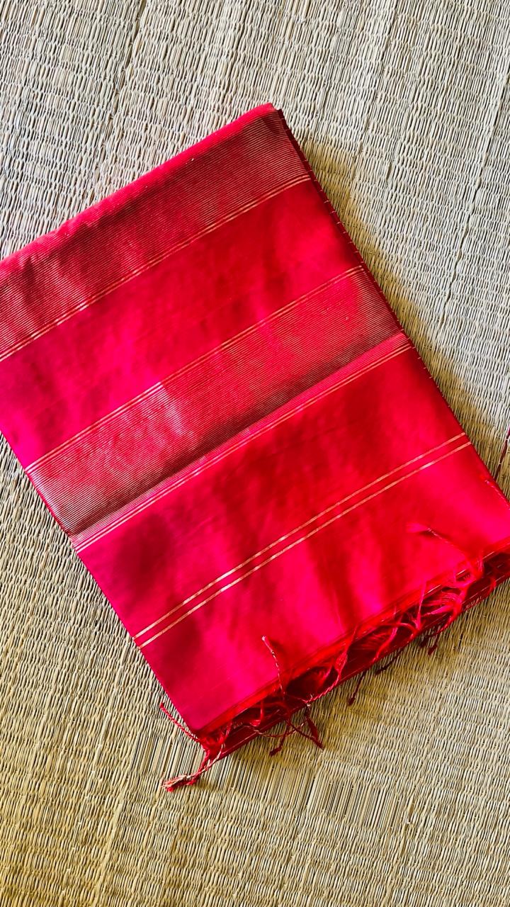 Folded Ranjani handwoven Maheswari saree showing pink body, zari border, and tassels