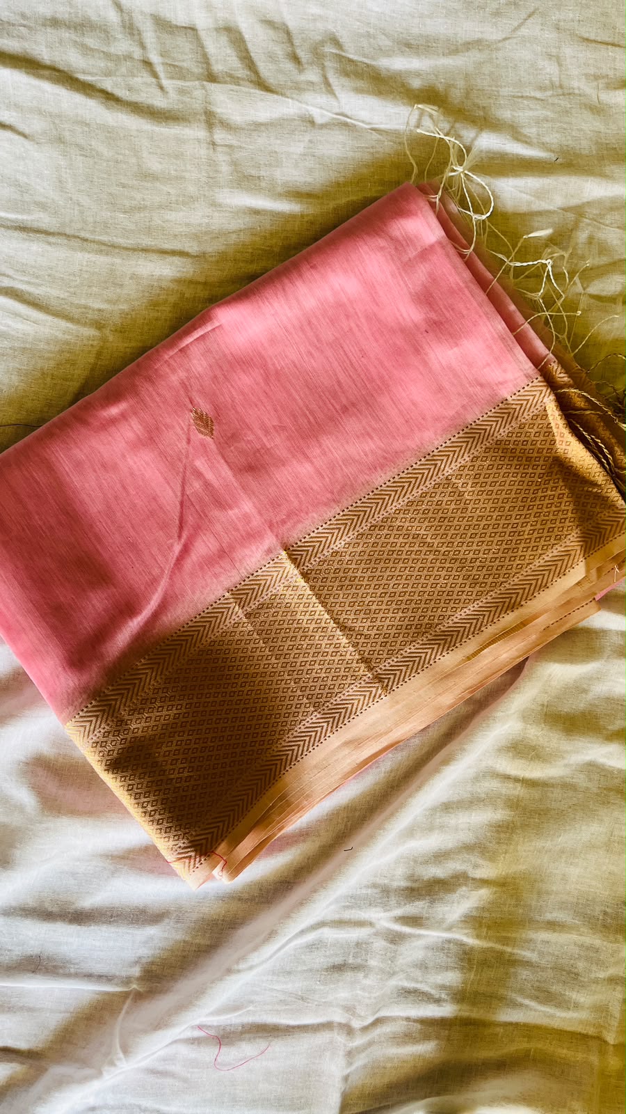 Gulabi-pink Maheswari saree with floral motifs and fine gold zari stripes