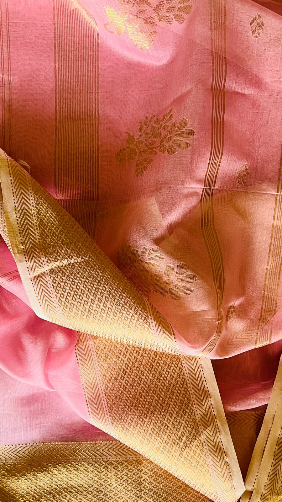 Gulabi-pink handwoven Maheswari saree with gold zari border, floral motifs, and patterned pallu