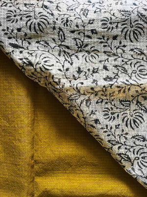 Close-up of Neelambari Kota Doria texture with mustard yellow and ivory floral detailing
